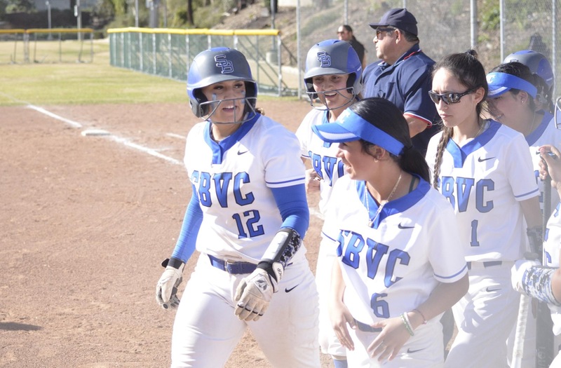 Hannah Guilfoos is surrounded by her teammates after blasting a three-run home run in game two of the doubleheader against Moorpark.